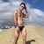 chico gay cachondo y vicioso en ropa de baño muy sexy tomando sol en la playa